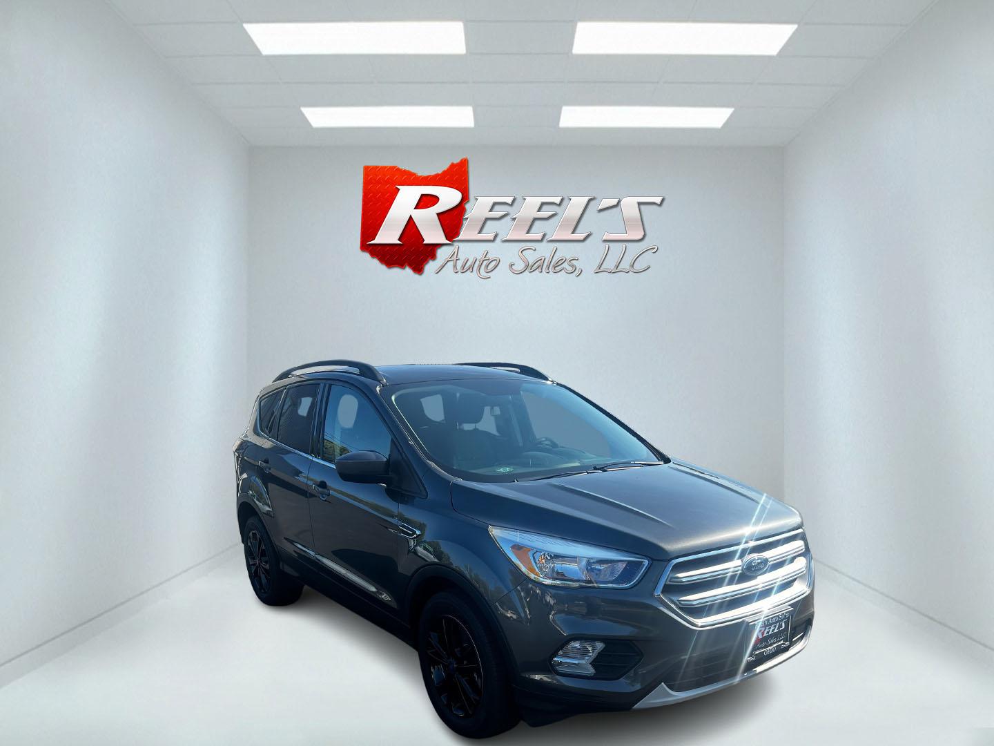 2018 Gray /Black Ford Escape SE 4WD (1FMCU9GD0JU) with an 1.5L I4 DOHC 16V TURBO engine, 6 Speed Auto transmission, located at 11115 Chardon Rd. , Chardon, OH, 44024, (440) 214-9705, 41.580246, -81.241943 - This 2018 Ford Escape SE 4WD is a compact SUV designed for efficiency and comfort, powered by a 1.5-liter turbocharged I4 EcoBoost engine, paired with a 6-speed automatic transmission, achieving an impressive 28 MPG on the highway. This Escape incorporates Auto Start Stop technology to enhance fuel - Photo#2