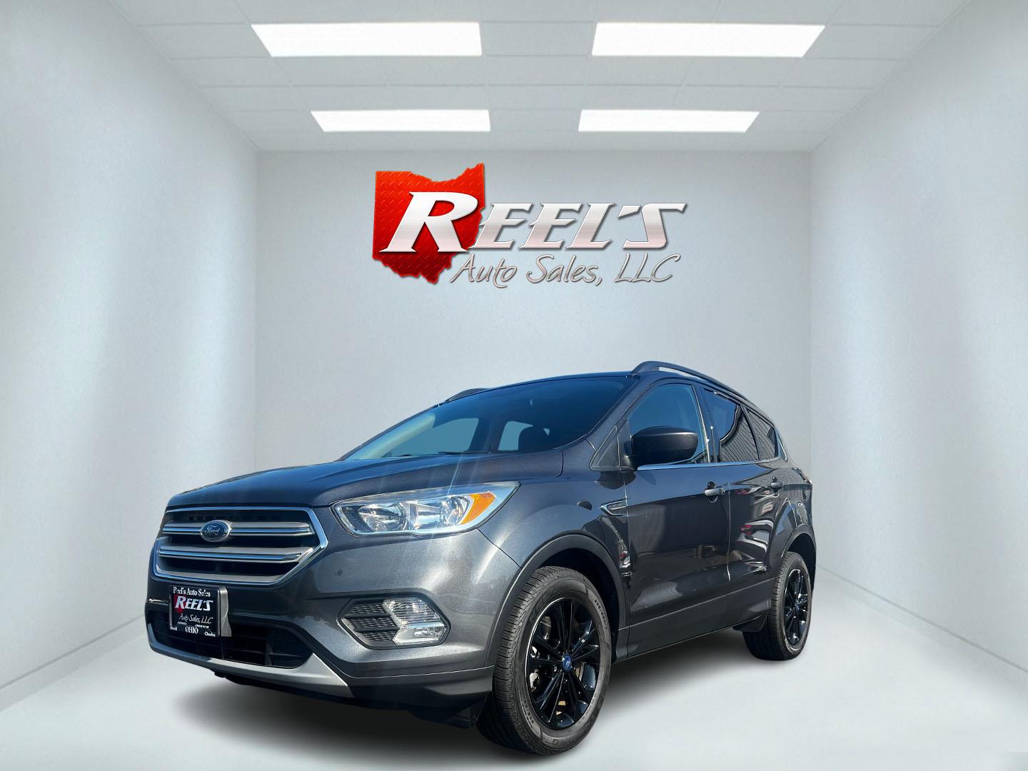 2018 Gray /Black Ford Escape SE 4WD (1FMCU9GD0JU) with an 1.5L I4 DOHC 16V TURBO engine, 6 Speed Auto transmission, located at 11115 Chardon Rd. , Chardon, OH, 44024, (440) 214-9705, 41.580246, -81.241943 - This 2018 Ford Escape SE 4WD is a compact SUV designed for efficiency and comfort, powered by a 1.5-liter turbocharged I4 EcoBoost engine, paired with a 6-speed automatic transmission, achieving an impressive 28 MPG on the highway. This Escape incorporates Auto Start Stop technology to enhance fuel - Photo#0