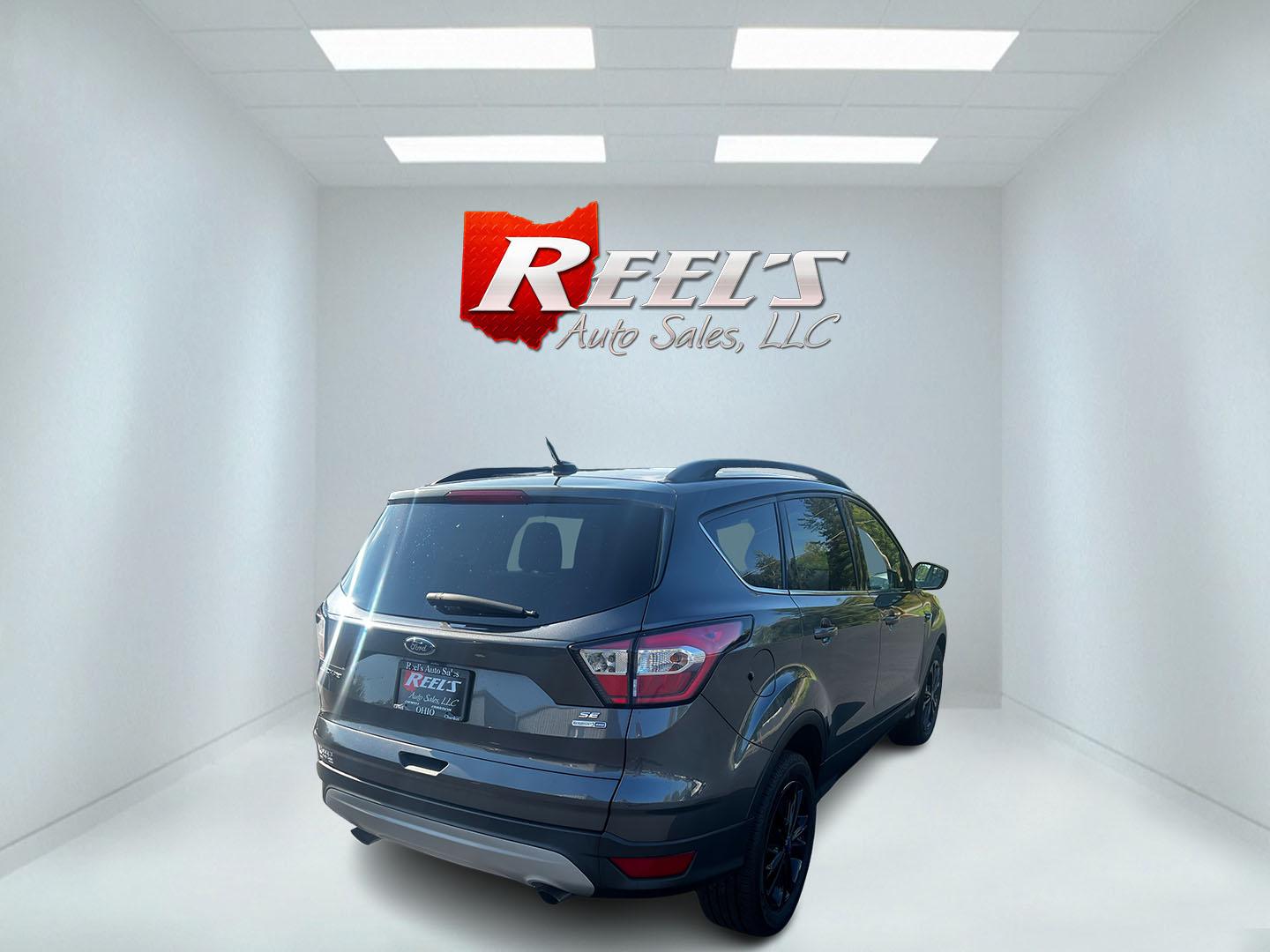 2018 Gray /Black Ford Escape SE 4WD (1FMCU9GD0JU) with an 1.5L I4 DOHC 16V TURBO engine, 6 Speed Auto transmission, located at 11115 Chardon Rd. , Chardon, OH, 44024, (440) 214-9705, 41.580246, -81.241943 - This 2018 Ford Escape SE 4WD is a compact SUV designed for efficiency and comfort, powered by a 1.5-liter turbocharged I4 EcoBoost engine, paired with a 6-speed automatic transmission, achieving an impressive 28 MPG on the highway. This Escape incorporates Auto Start Stop technology to enhance fuel - Photo#5