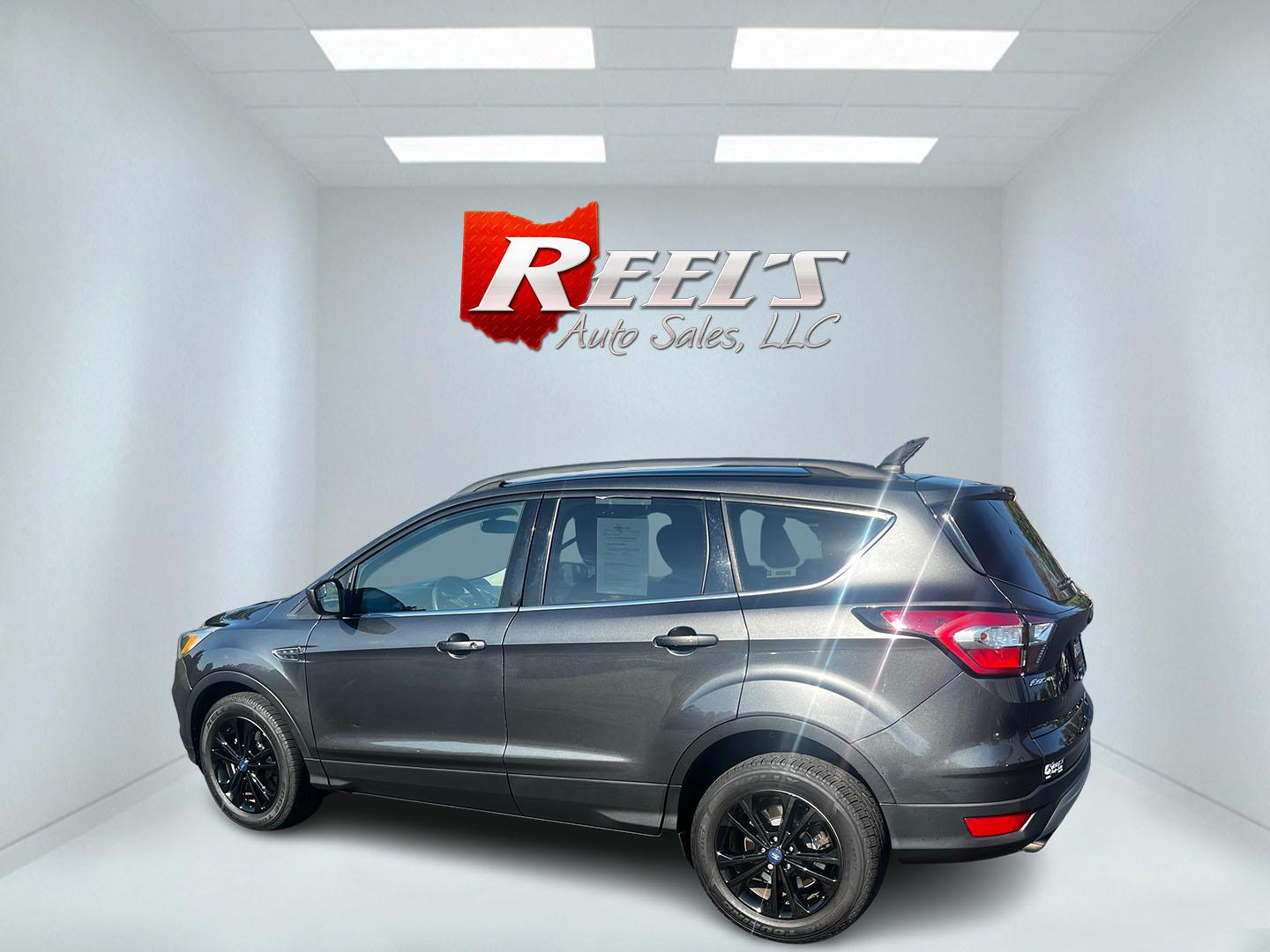 2018 Gray /Black Ford Escape SE 4WD (1FMCU9GD0JU) with an 1.5L I4 DOHC 16V TURBO engine, 6 Speed Auto transmission, located at 11115 Chardon Rd. , Chardon, OH, 44024, (440) 214-9705, 41.580246, -81.241943 - This 2018 Ford Escape SE 4WD is a compact SUV designed for efficiency and comfort, powered by a 1.5-liter turbocharged I4 EcoBoost engine, paired with a 6-speed automatic transmission, achieving an impressive 28 MPG on the highway. This Escape incorporates Auto Start Stop technology to enhance fuel - Photo#8