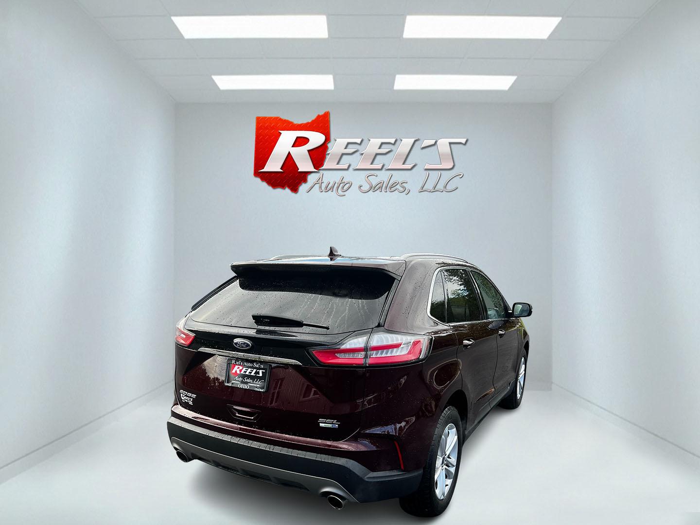 2019 Burgundy /Black Ford Edge SEL AWD (2FMPK4J96KB) with an 2.0L I4 DOHC 16V Turbo engine, 8-Speed Automatic transmission, located at 11115 Chardon Rd. , Chardon, OH, 44024, (440) 214-9705, 41.580246, -81.241943 - This One Owner 2019 Ford Edge SEL AWD is a sophisticated midsize SUV combining performance, technology, and comfort. It features a 2.0-liter turbocharged I4 EcoBoost engine with a 8-speed automatic transmission, providing a balanced driving experience with efficiency and power. The interior is well- - Photo#5