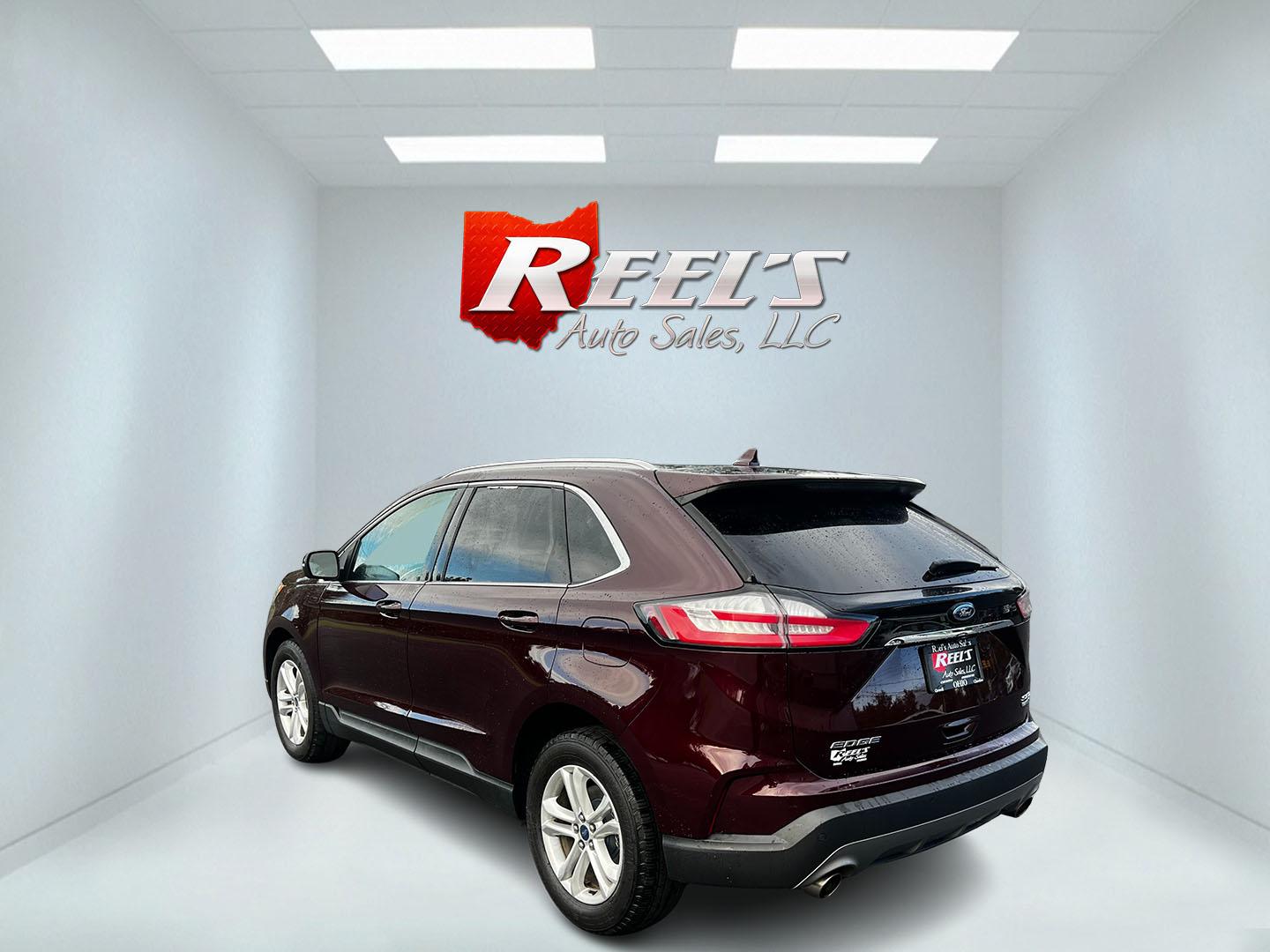 2019 Burgundy /Black Ford Edge SEL AWD (2FMPK4J96KB) with an 2.0L I4 DOHC 16V Turbo engine, 8-Speed Automatic transmission, located at 11115 Chardon Rd. , Chardon, OH, 44024, (440) 214-9705, 41.580246, -81.241943 - This One Owner 2019 Ford Edge SEL AWD is a sophisticated midsize SUV combining performance, technology, and comfort. It features a 2.0-liter turbocharged I4 EcoBoost engine with a 8-speed automatic transmission, providing a balanced driving experience with efficiency and power. The interior is well- - Photo#7