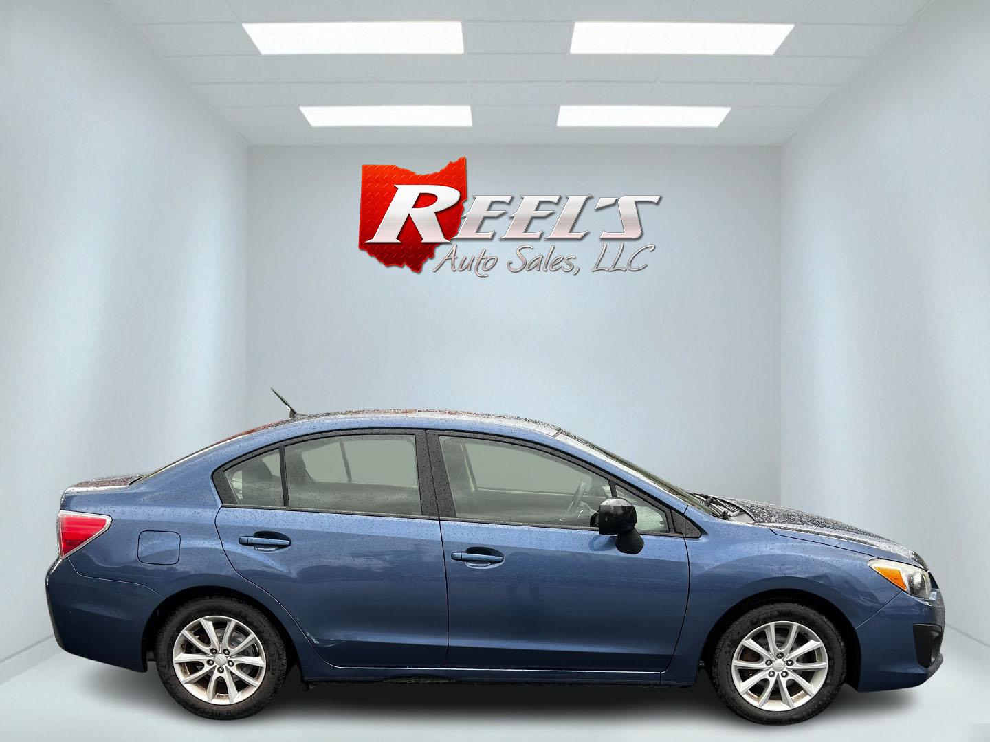 2013 Blue /Black Subaru Impreza 2.0i Premium 4-Door w/All Weather Package (JF1GJAC68DH) with an 2.0L H4 DOHC 16V engine, Automatic transmission, located at 11115 Chardon Rd. , Chardon, OH, 44024, (440) 214-9705, 41.580246, -81.241943 - This 2013 Subaru Impreza Premium offers a balanced combination of efficiency and all-weather capability, featuring a 2.0-liter H4 PZEV engine that achieves an impressive 35 MPG on the highway. This model is equipped with Subaru's renowned Symmetrical All-Wheel Drive system, delivering enhanced stabi - Photo#4