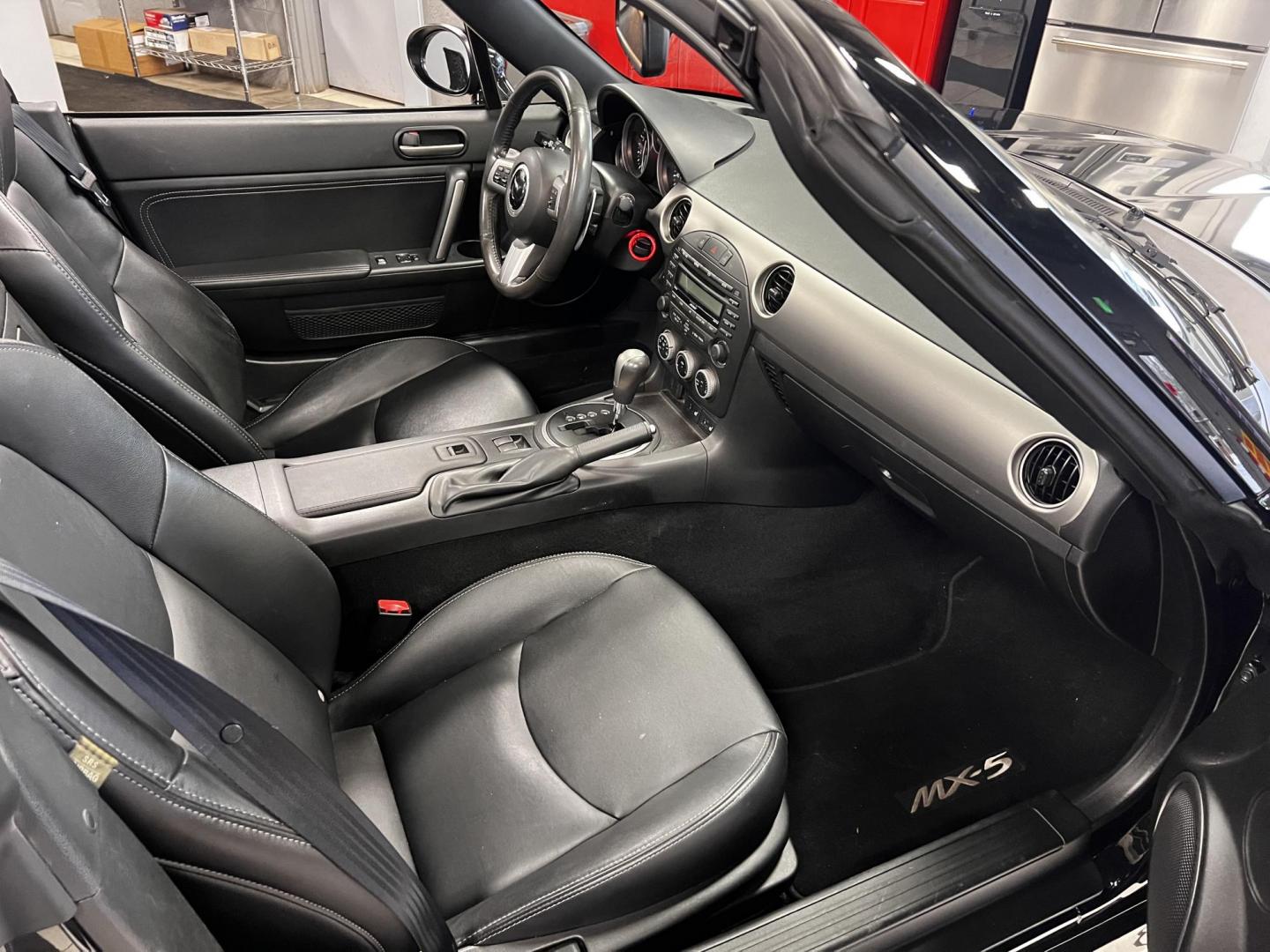 2012 Black /Black Mazda MX-5 Miata Grand Touring (JM1NC2PFXC0) with an 2.0L I4 DOHC 16V engine, 6 Speed Automatic transmission, located at 547 E. Main St., Orwell, OH, 44076, (440) 437-5893, 41.535435, -80.847855 - This 2012 Mazda MX-5 Miata Grand Touring with a hardtop features a 2.0-liter inline-four engine paired with a 6-speed automatic transmission, making it a stylish and sporty option for roadster enthusiasts. It comes equipped with HID headlights that enhance visibility and a premium leather interior g - Photo#28