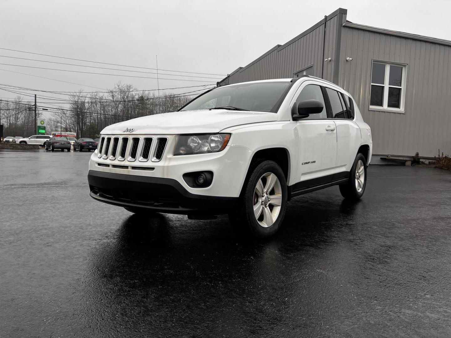 2016 White /Black Jeep Compass Sport 4WD (1C4NJDBB0GD) with an 2.4L I4 DOHC 16V engine, 6 Speed Auto transmission, located at 11115 Chardon Rd. , Chardon, OH, 44024, (440) 214-9705, 41.580246, -81.241943 - This 2016 Jeep Compass Sport 4WD is a compact SUV designed for versatility and efficiency, featuring a 2.4L I4 engine coupled with a 6-speed automatic transmission. It offers practical features such as an auto-dimming rearview mirror for reduced glare, dusk-sensing headlights for enhanced visibility - Photo#0