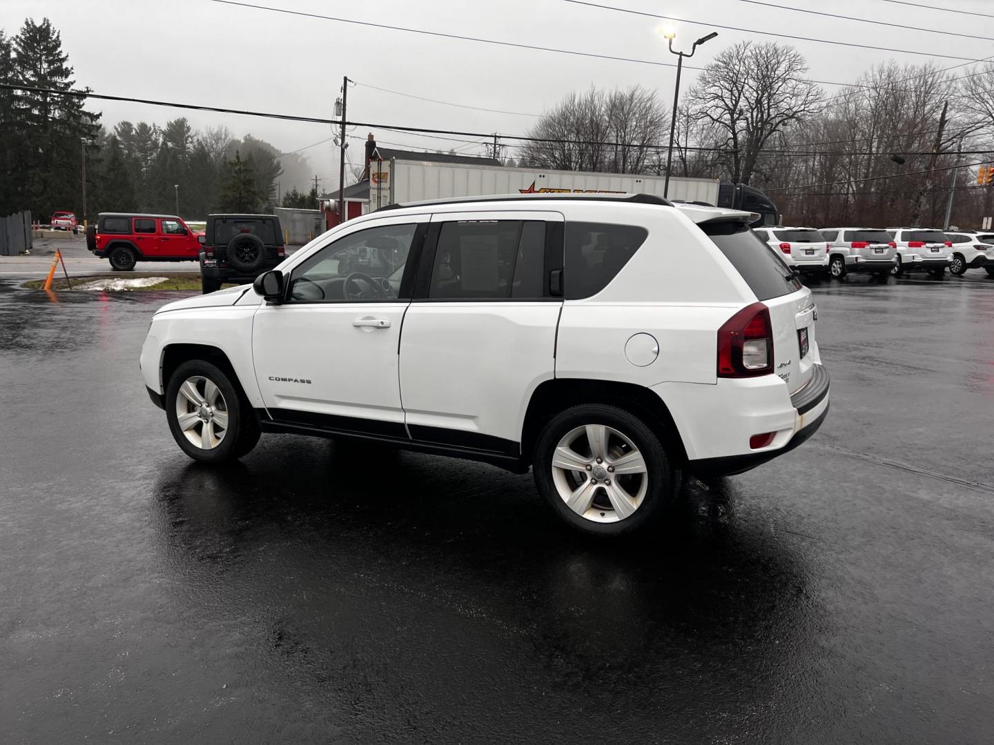 2016 White /Black Jeep Compass Sport 4WD (1C4NJDBB0GD) with an 2.4L I4 DOHC 16V engine, 6 Speed Auto transmission, located at 11115 Chardon Rd. , Chardon, OH, 44024, (440) 214-9705, 41.580246, -81.241943 - This 2016 Jeep Compass Sport 4WD is a compact SUV designed for versatility and efficiency, featuring a 2.4L I4 engine coupled with a 6-speed automatic transmission. It offers practical features such as an auto-dimming rearview mirror for reduced glare, dusk-sensing headlights for enhanced visibility - Photo#11