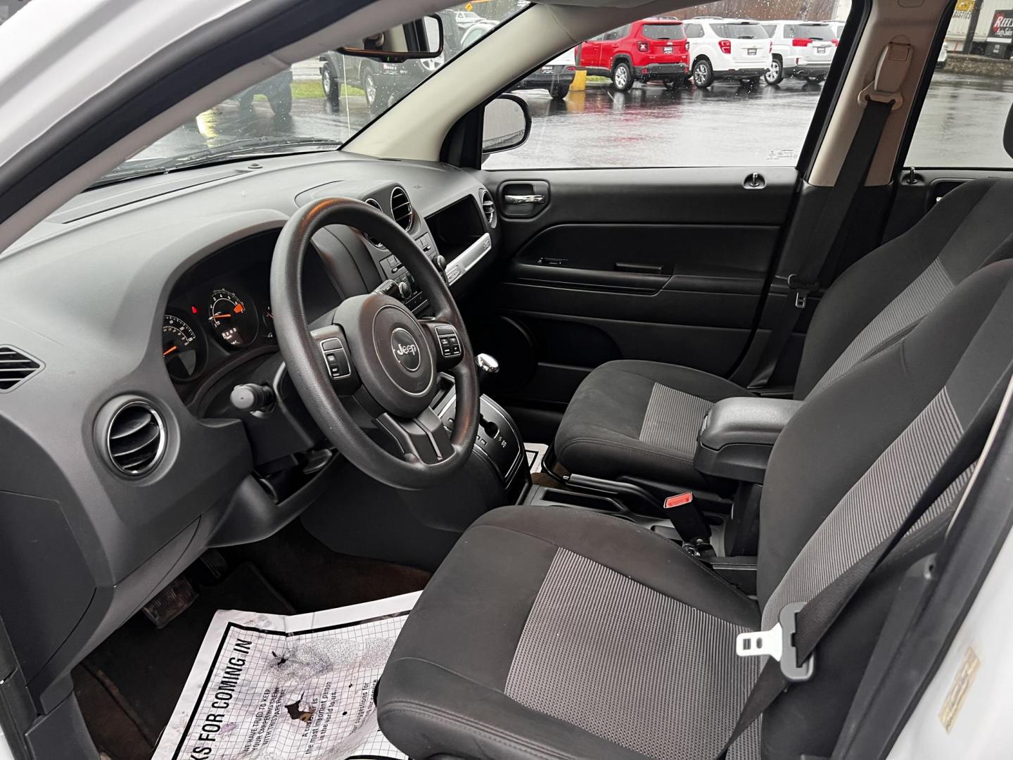 2016 White /Black Jeep Compass Sport 4WD (1C4NJDBB0GD) with an 2.4L I4 DOHC 16V engine, 6 Speed Auto transmission, located at 11115 Chardon Rd. , Chardon, OH, 44024, (440) 214-9705, 41.580246, -81.241943 - This 2016 Jeep Compass Sport 4WD is a compact SUV designed for versatility and efficiency, featuring a 2.4L I4 engine coupled with a 6-speed automatic transmission. It offers practical features such as an auto-dimming rearview mirror for reduced glare, dusk-sensing headlights for enhanced visibility - Photo#15